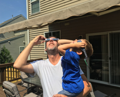 David and his son observing the solar eclipse