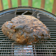 Basting the pork butt with sauce