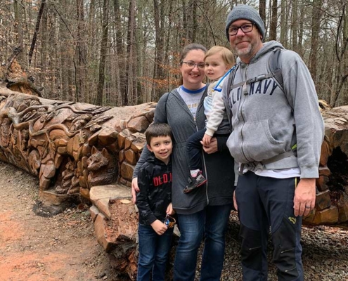 In front of the log art at Umstead Park