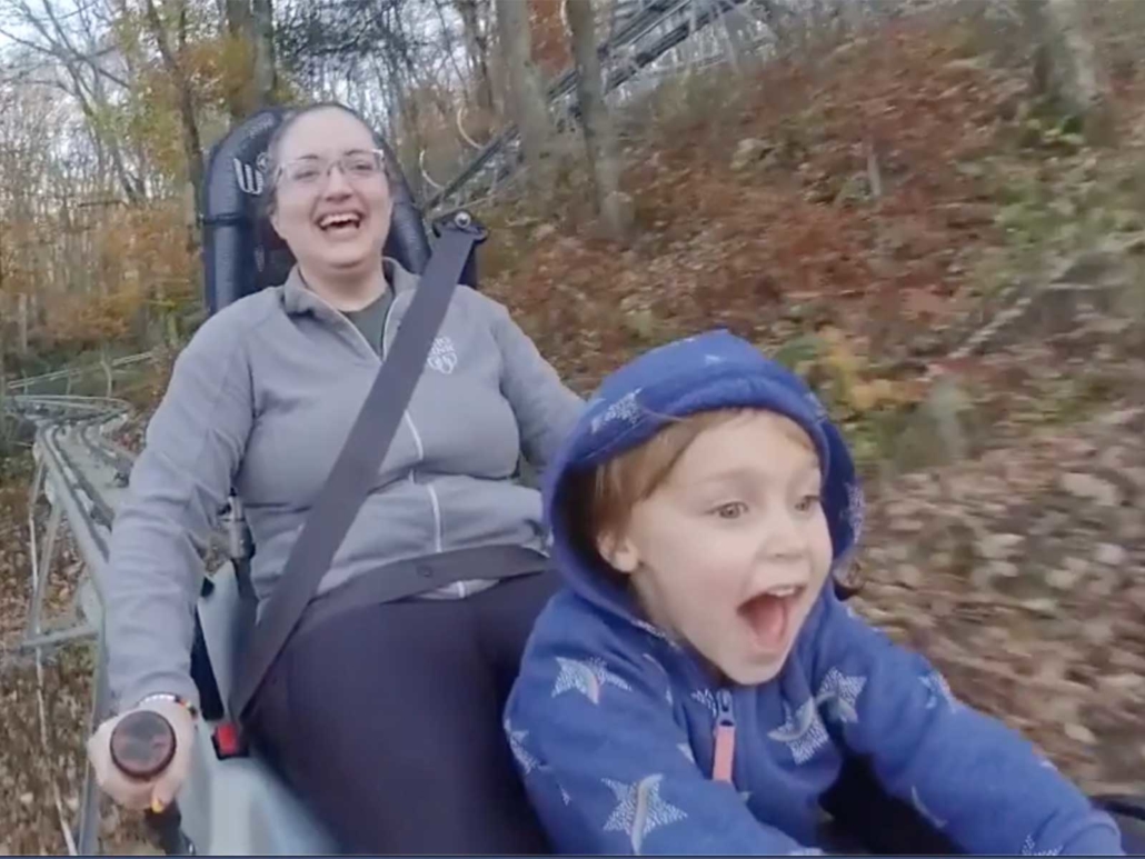 Jen taking Emily for a ride on an alpine coaster